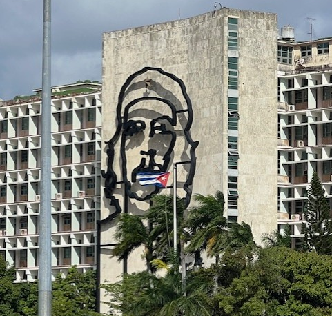 A romanticized wall painting of Fidel hides the fact that most buildings in Cuba are crumbling.