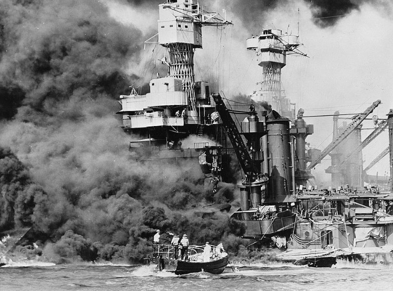 A small boat tries to rescue sailors from the burning USS West Virginia. 