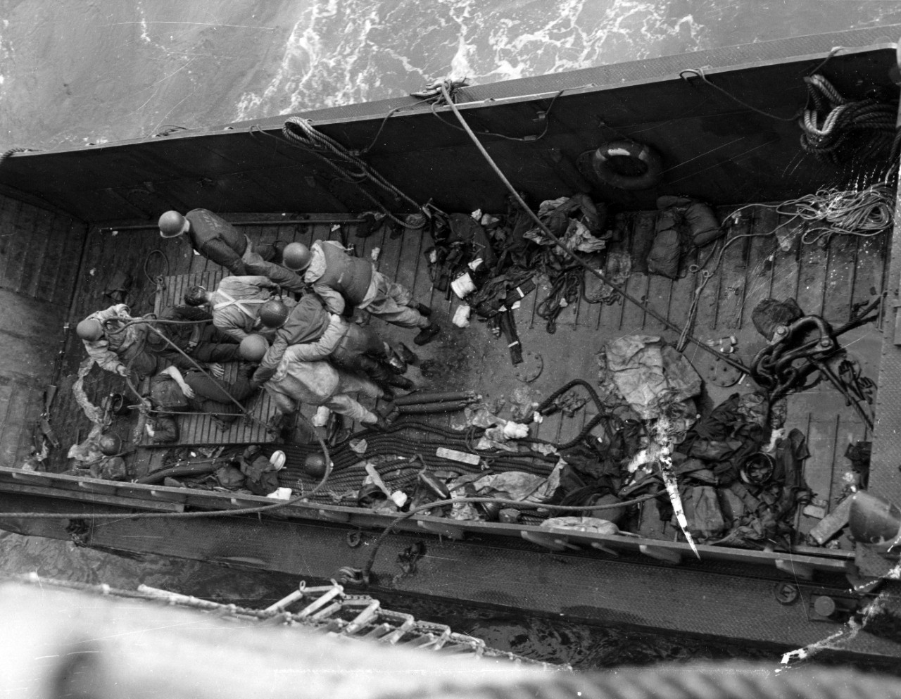 Casualties are transferred from an LCM to a larger ship for evacuation from the Normandy area. Photograph released 8 June 1944. Official U.S. Navy Photograph, now in the collections of the National Archives.