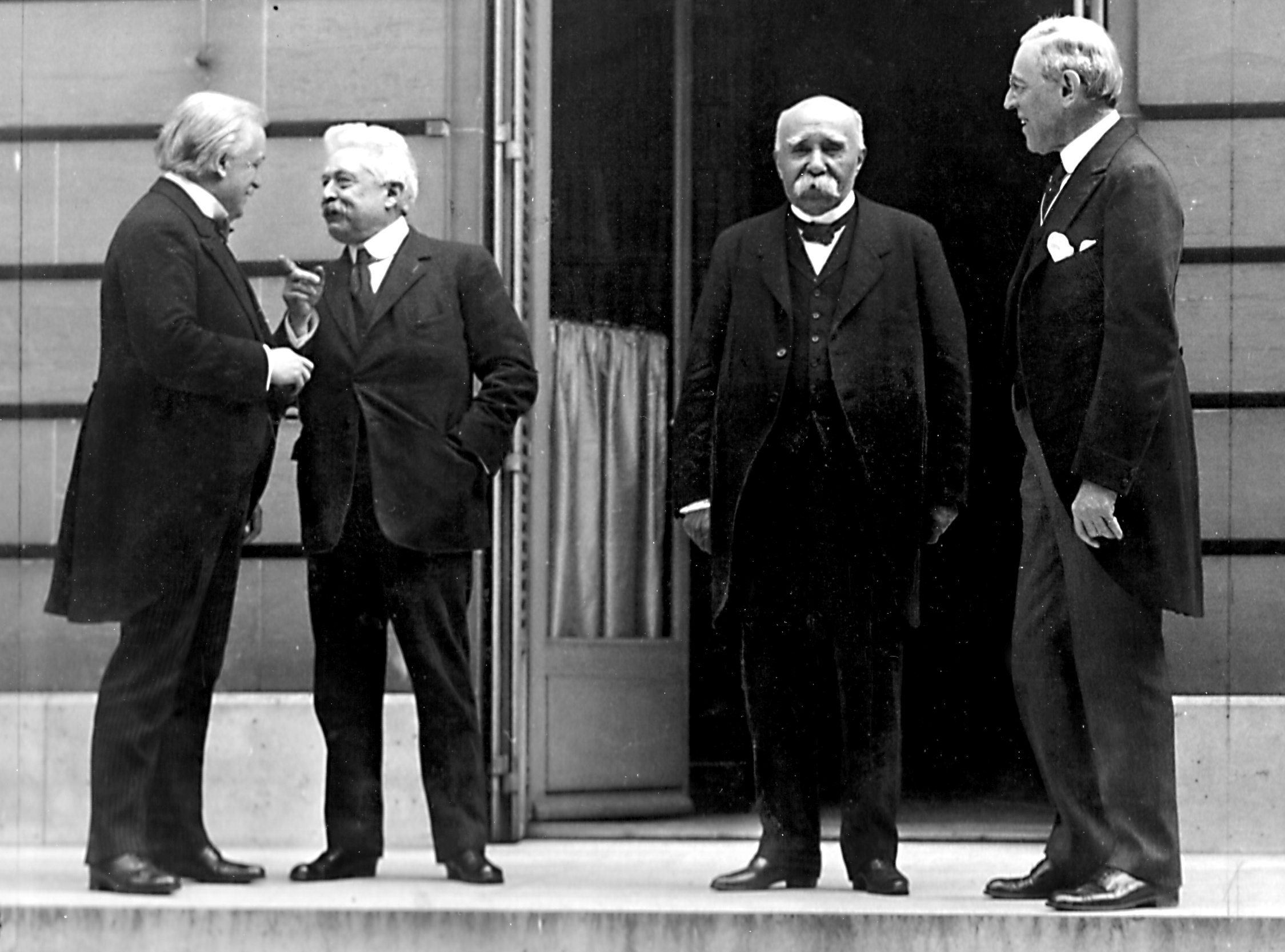 The Council of Four at the Paris Peace Conference, including British Prime Minister David Lloyd George, Italian Premier Vittorio Orlando, French Premier Georges Clemenceau, and US President Woodrow Wilson. Image courtesy Wikimedia.