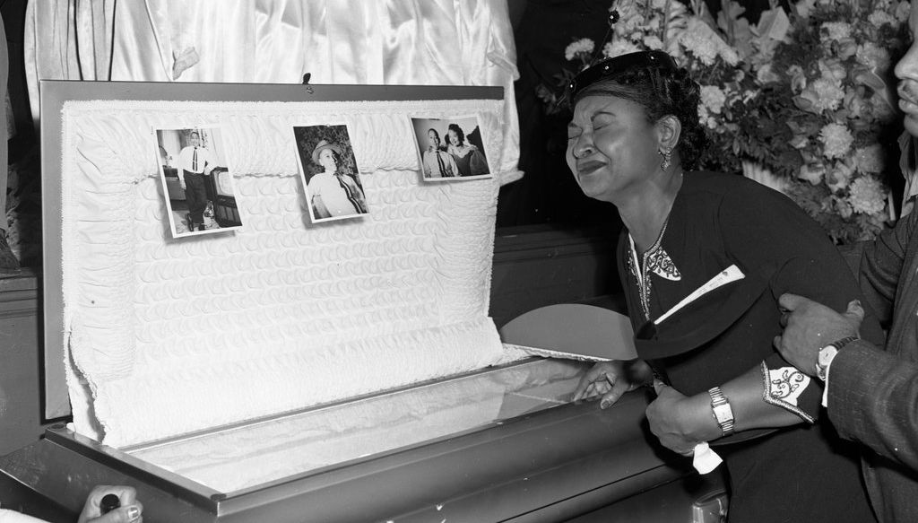 Mamie Bradley grieving over the casket of her son, Emmett Till, Chicago Historical Society