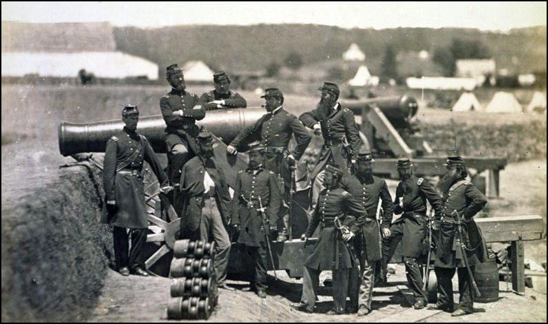 Officers of the 69th New York Volunteer Regiment pose with a cannon at Fort Corcoran in 1861. Michael Corcoran at left. Library of Congress